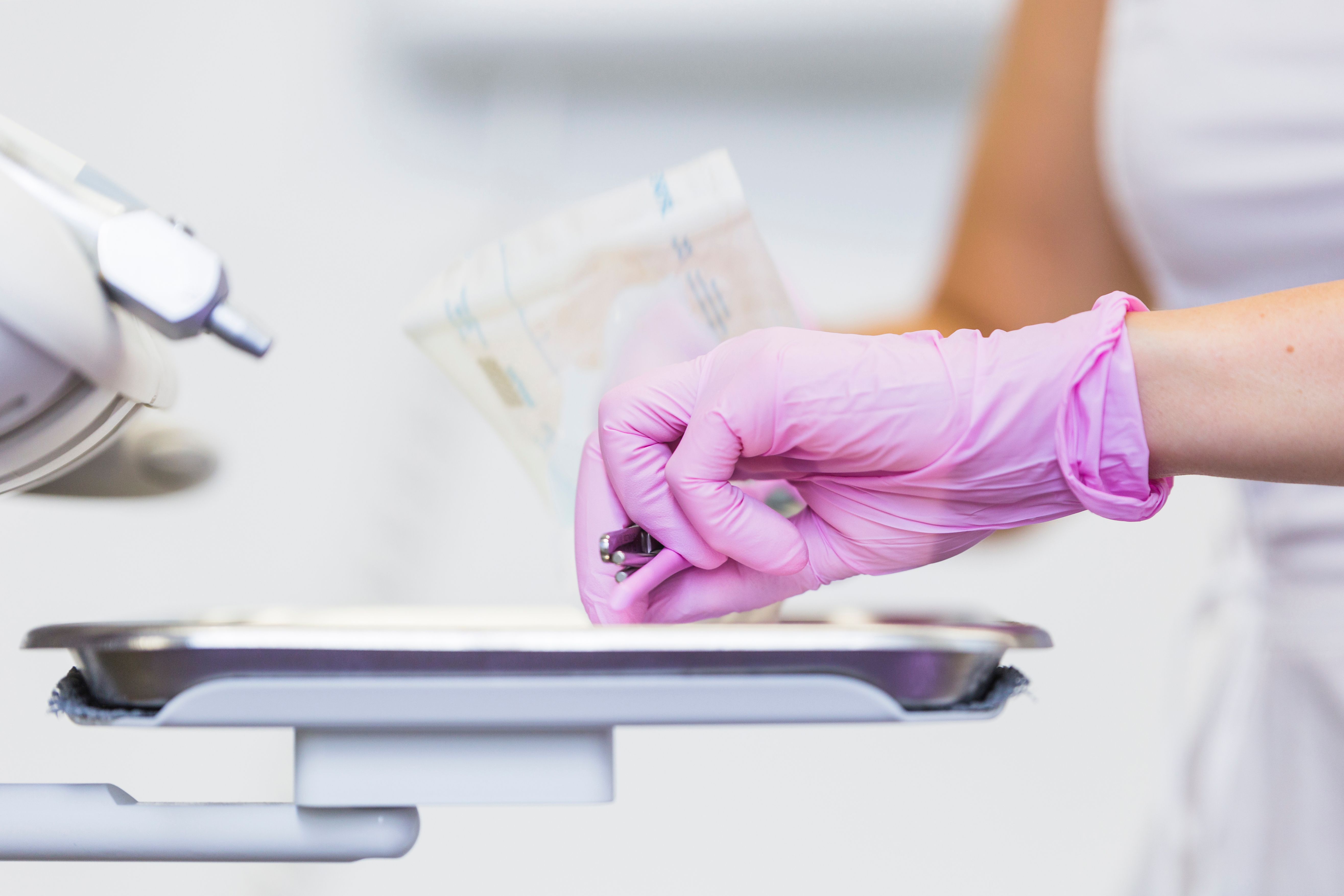 close-up-dentist-s-hand-holding-dental-tools.jpg