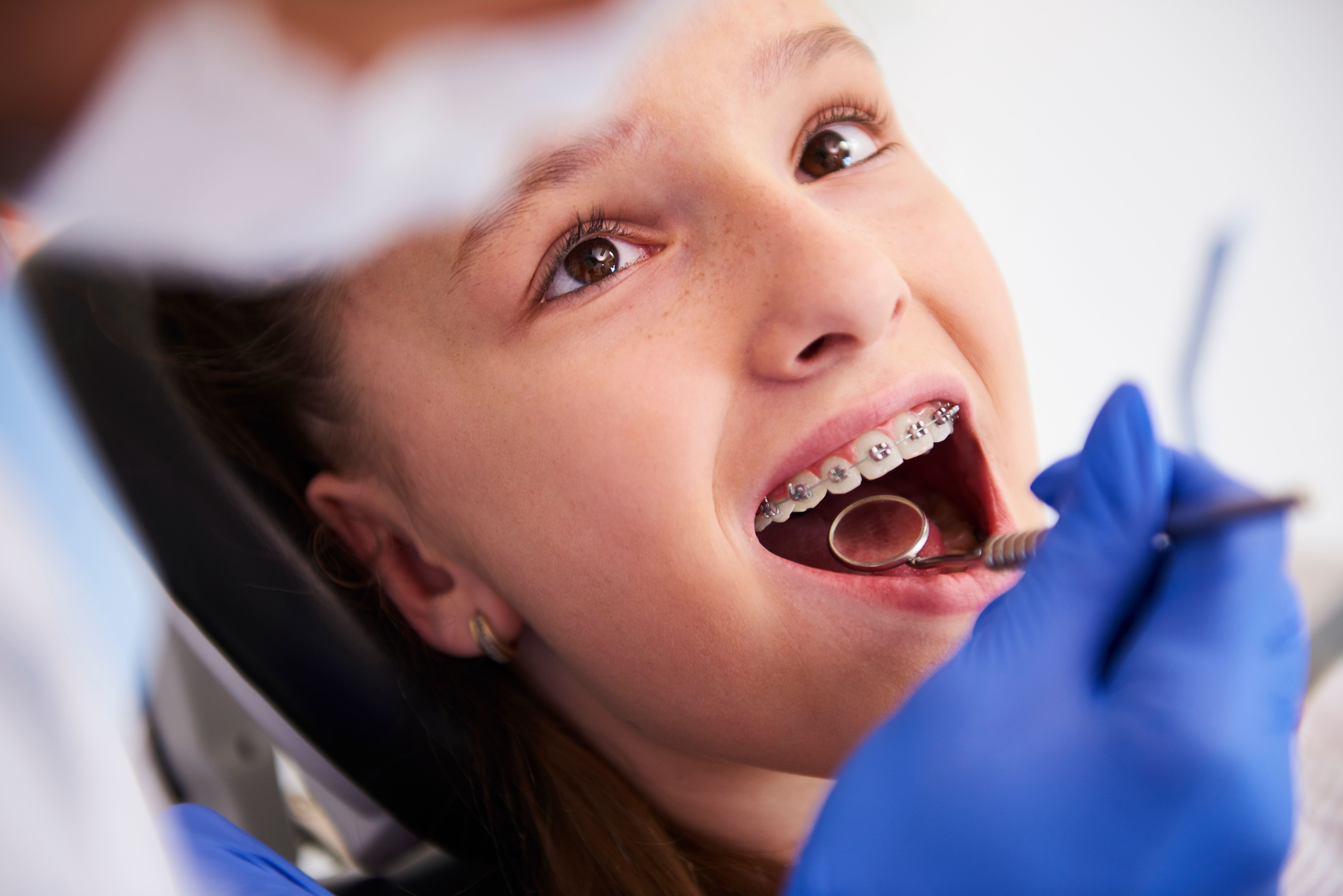 girl-with-braces-routine-dental-examination